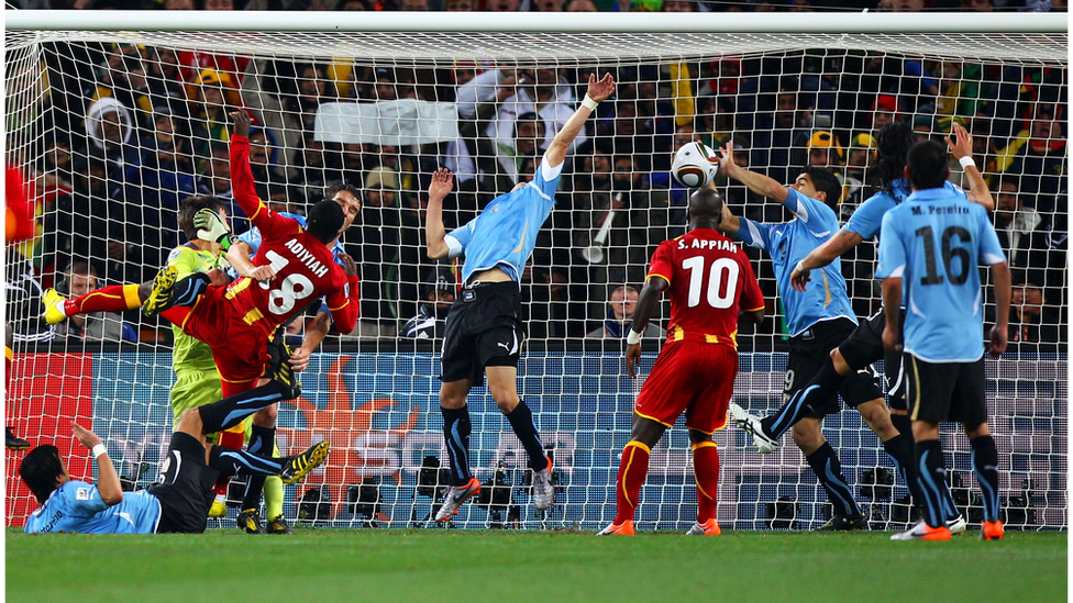 Luis Suarez palms the ball off the line from Dominic Adiyah's header.