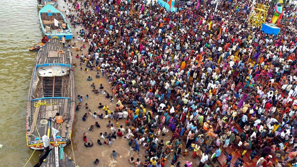 Thousands of people gather during a Hindu religious bathing festival on the bank of the Godavari River in Rajahmundry, Andhra Pradesh state, India, Tuesday