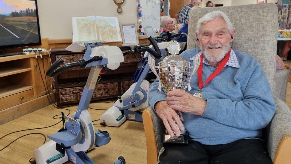 Kenneth Judd with his medal and trophy