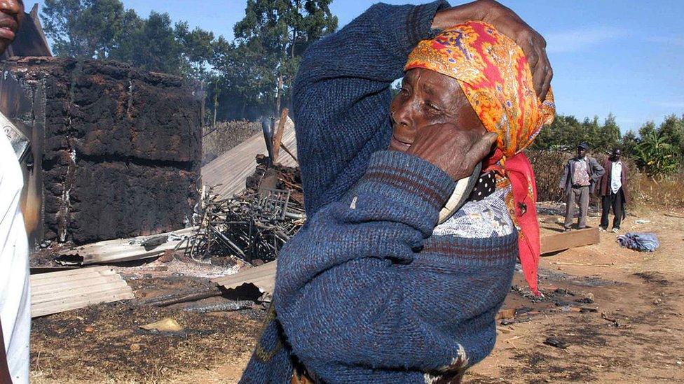 A Kenyan woman reacts outside the Kenya Assemblies of God Church in Eldoret, 01 January 2008.