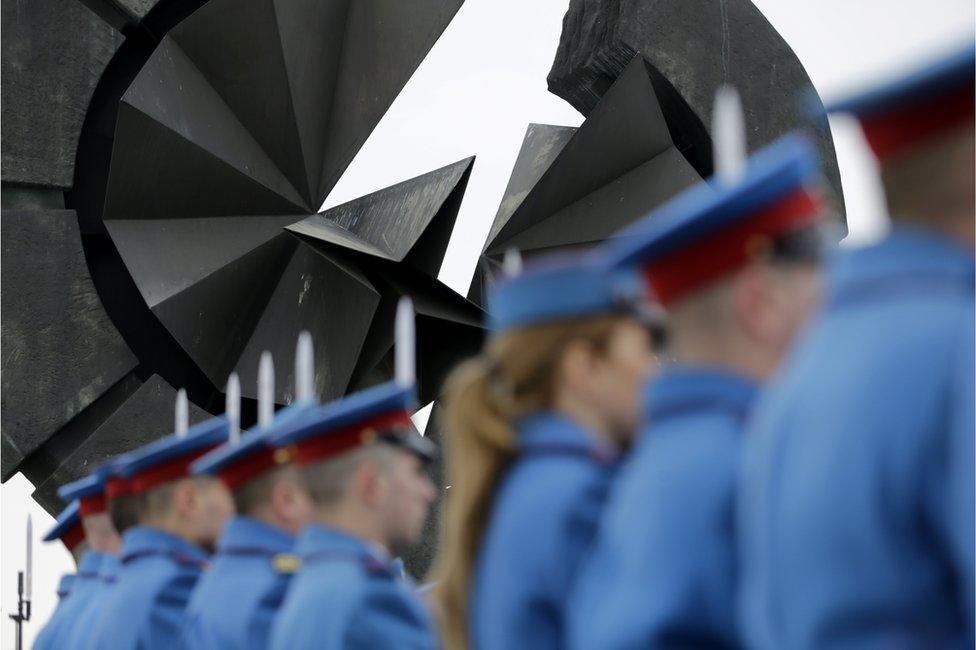 In Belgrade, Serbia, members of the guard of honor of the Serbian Army take part in a memorial service at the monument for victims of the Nazi concentration camp Sajmiste