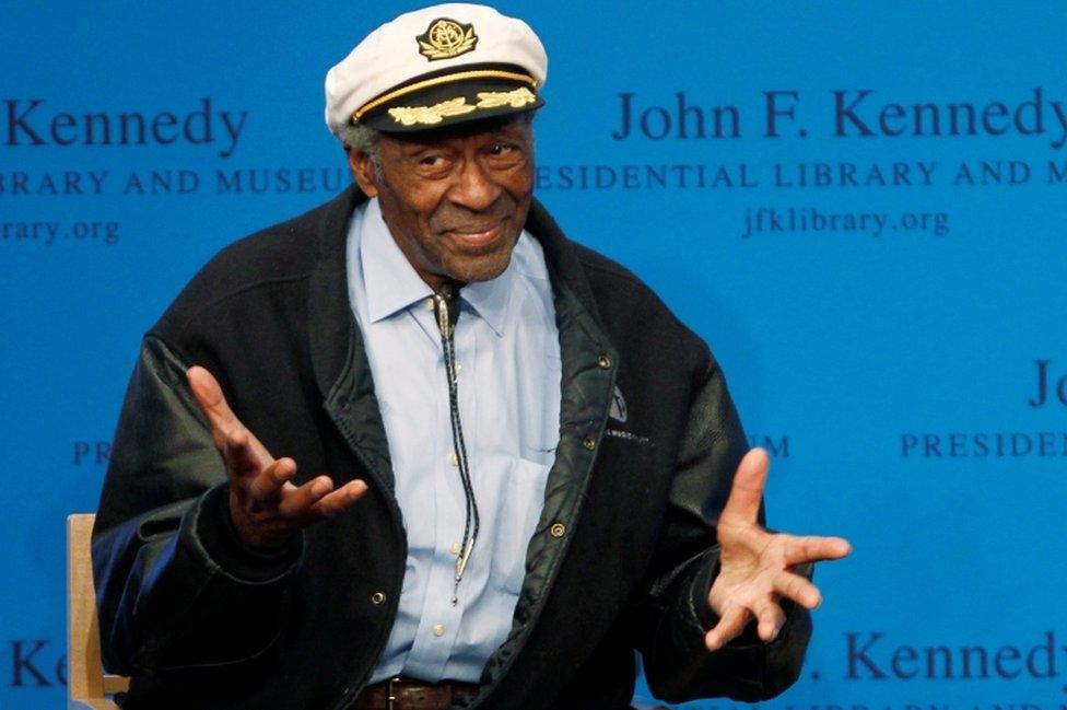 Chuck Berry gestures to the audience at the 2012 Awards for Song Lyrics of Literary Excellence awarded to both him and Leonard Cohen at the John F. Kennedy Presidential Library and Museum in Boston, Massachusetts February 26, 2012.