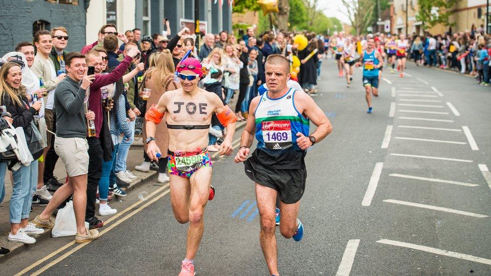 Joe Spraggins dressed as a swimmer runs the London Marathon