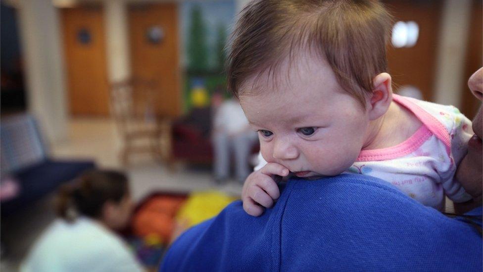 A woman helps out with a fellow inmate's child at a correctional centre in Illinois