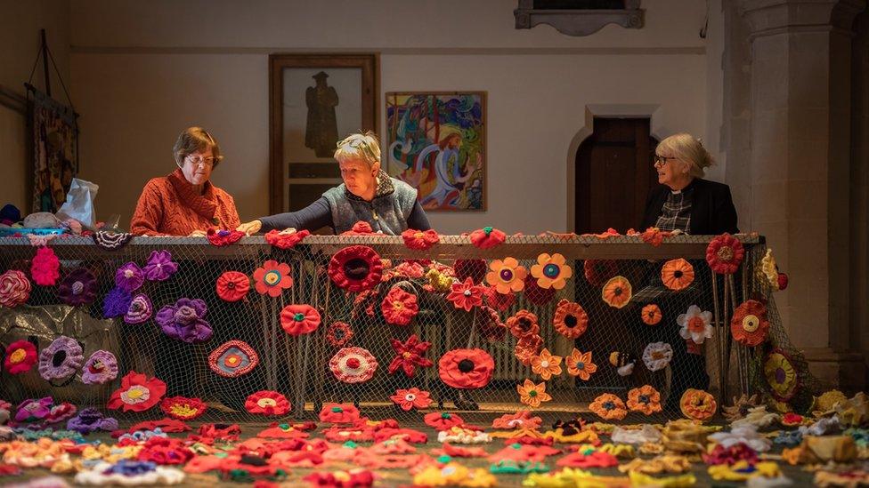 Women sewing flowers in a church