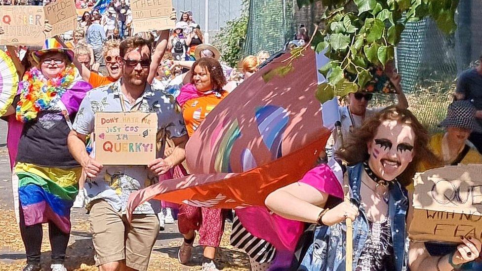 People walking with banners and bright colours