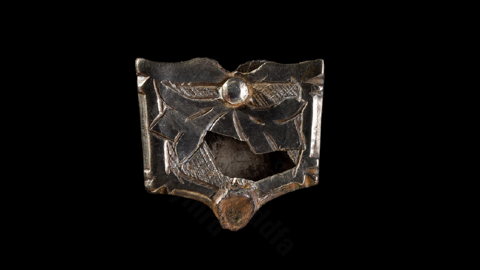 Medieval belt strap with a pattern carved in the centre