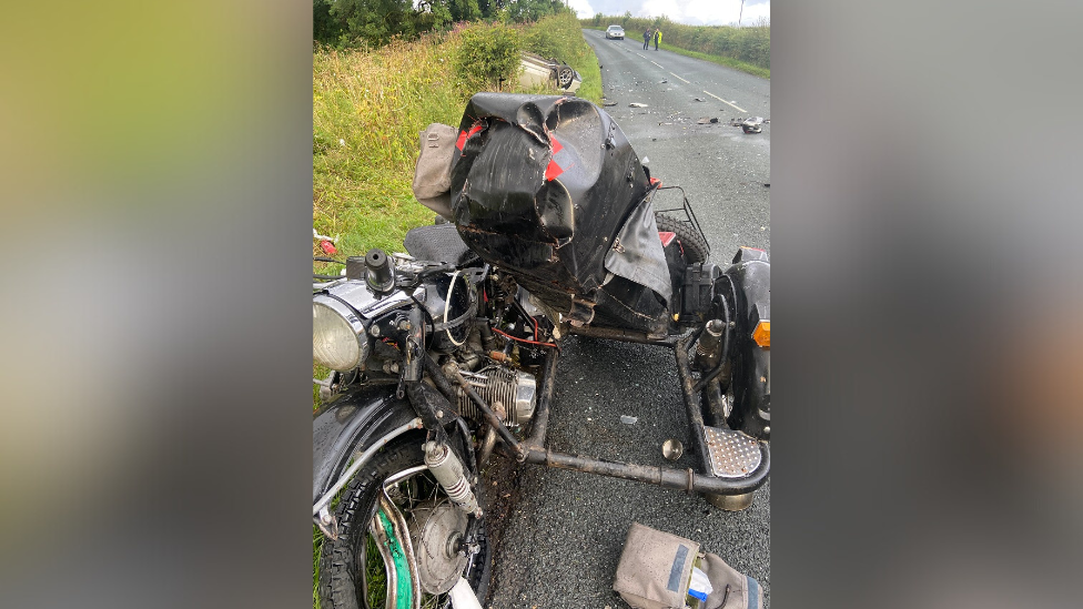 Ural motorbike on the roadside with serious damage 