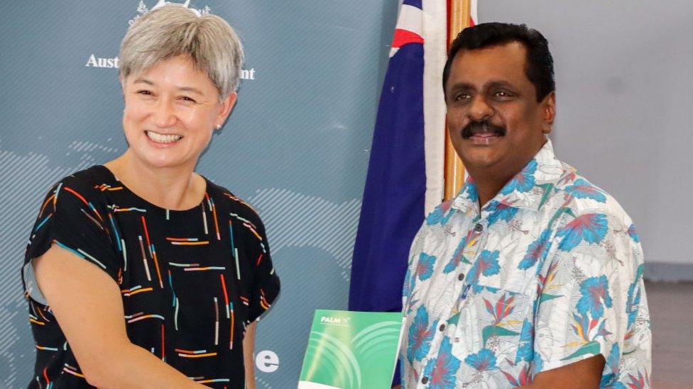 Australian Foreign Minister Penny Wong shakes hands with Fiji Minister for Employment Praveen Bala