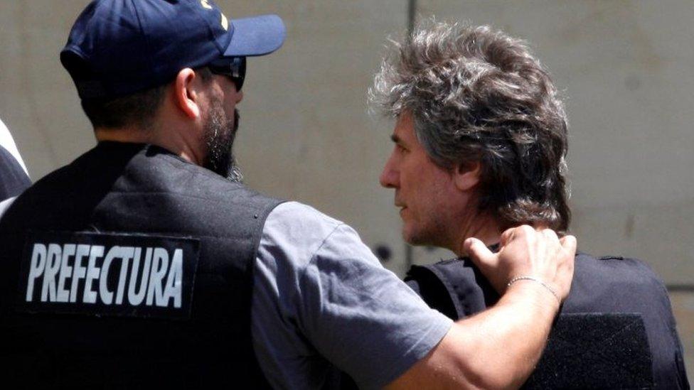 Former Argentine Vice President Amado Boudou is escorted by a member of Argentina"s Coastguards as he arrives to a Federal Justice building in Buenos Aires, Argentina November 3, 2017. REUTERS