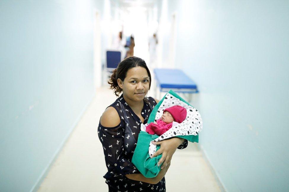 Jackeline, 24, a Venezuelan from Bolivar state, holds her four-day-old baby Sofia at a maternity hospital in Boa Vista, Roraima state, Brazil, 21 August 2018