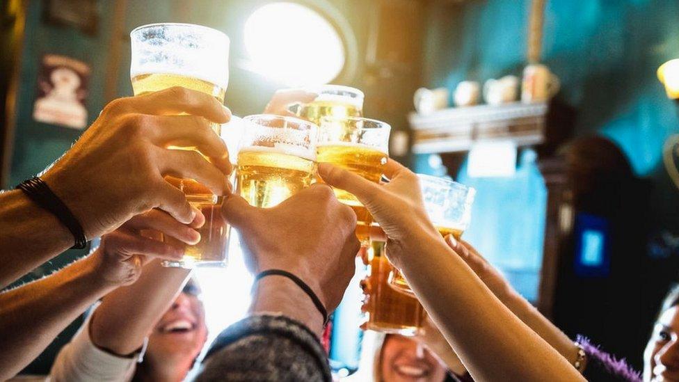 A group of friends having a drink in a pub