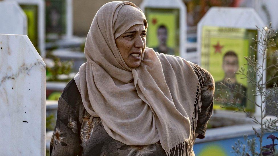 A Kurdish Syrian woman cries during the funeral of five Syrian Democratic Forces fighters killed in battles against Turkey-led forces in the flashpoint town of Ras al-Ain along the border, on October 14, 2019