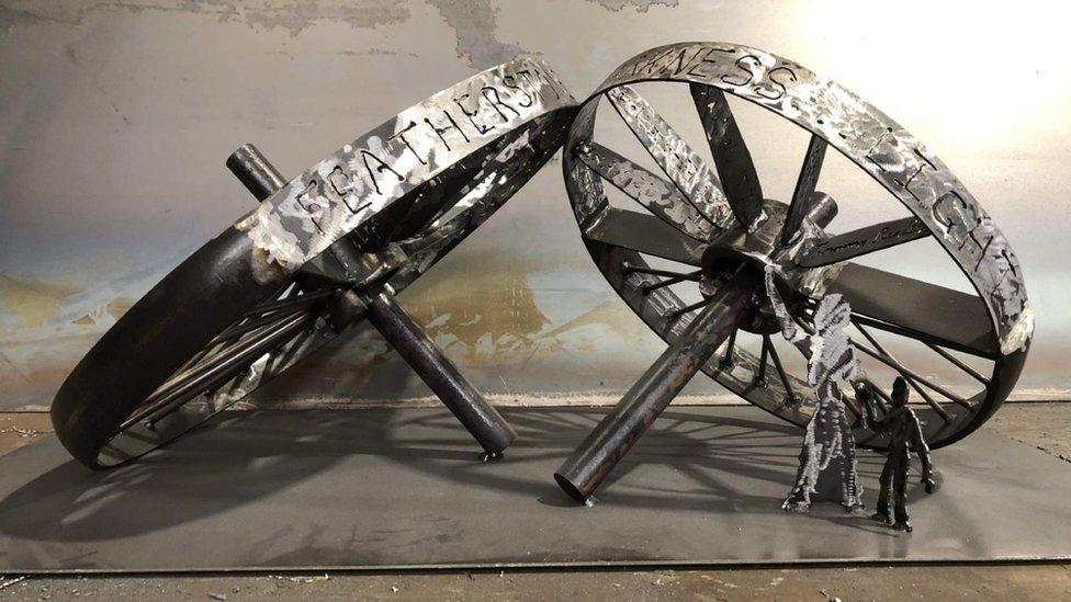 The Unbroken Wheel sculpture, featuring two decommissioned mining wheels