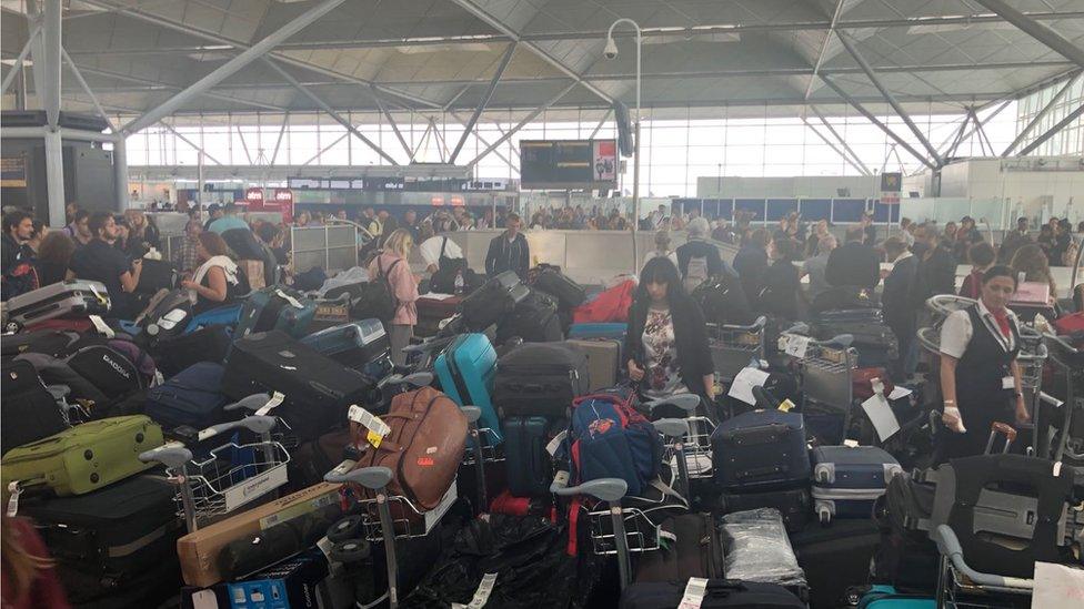 Baggage and passengers waiting at Stansted