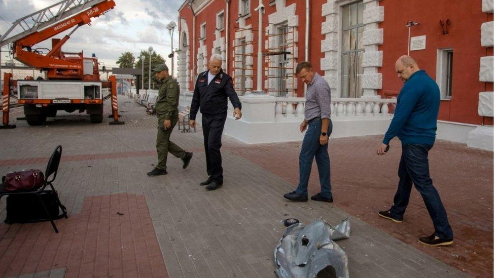 Governor of the Kursk Region Roman Starovoit inspects a damaged railway station following a reported drone attack in Kursk