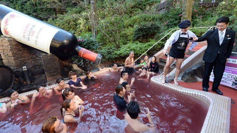 Beaujolais Nouveau wine is poured into the wine spa at the Hakone Yunessun spa in Hakone town, Japan