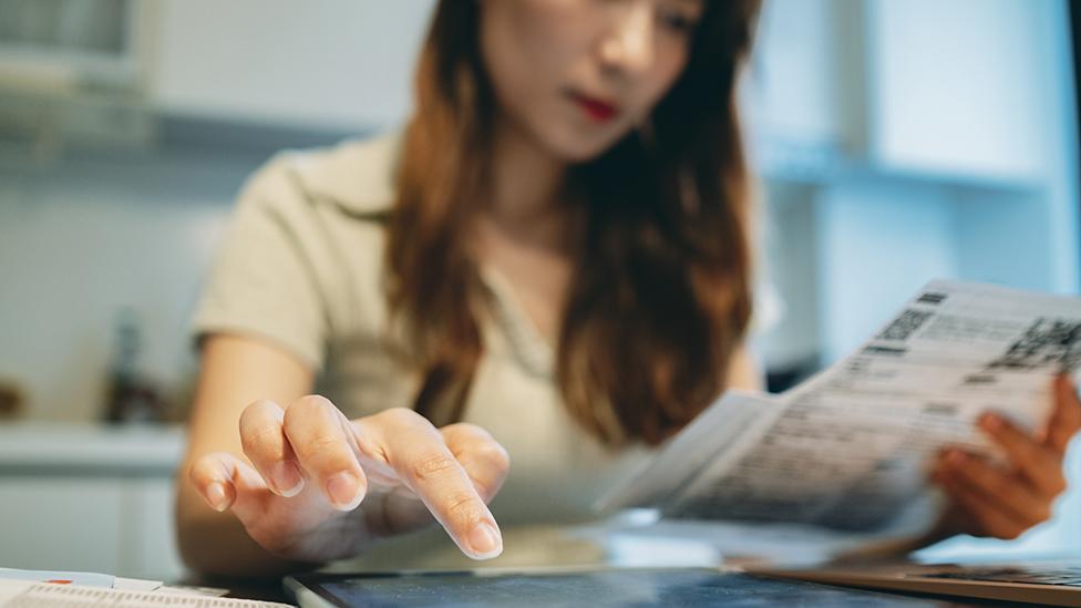 Woman looking at bills