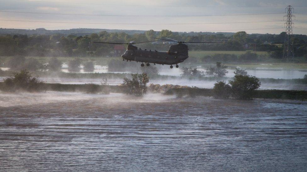 A-British-Royal-Air-Force-helicopter-trying-to-stop-the-flow-of-water-in-Wainfleet