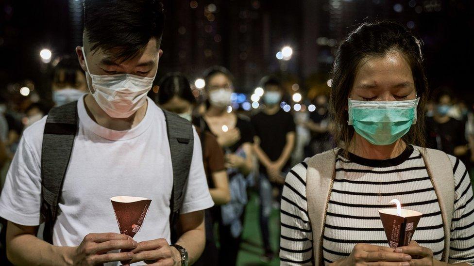 People hold their candles during the 31st Anniversary of the Tiananmen Massacre.