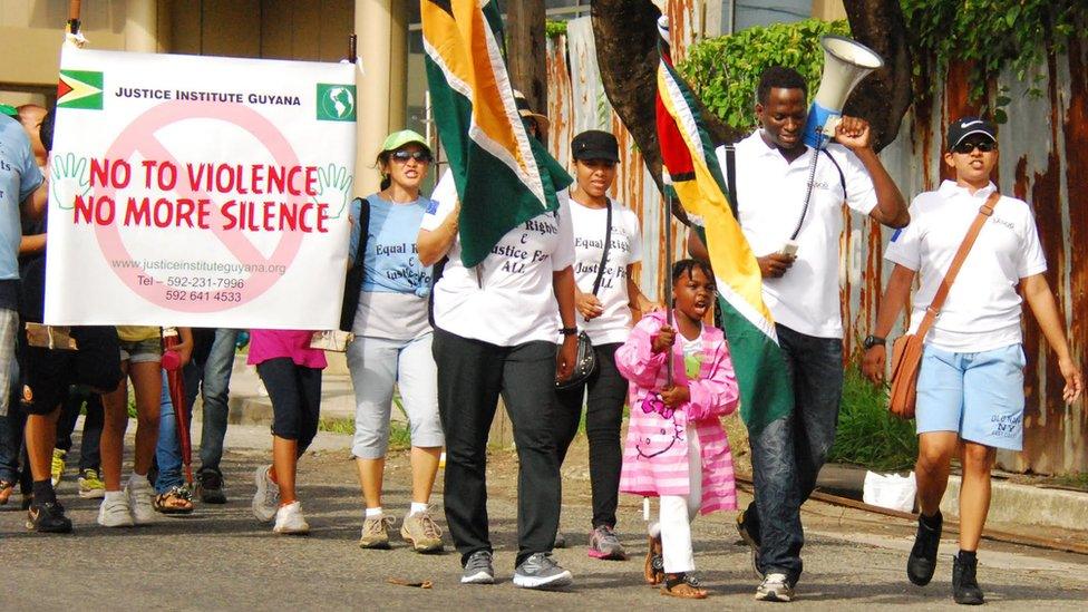 SASOD activists on a march holding banners demanding "no more violence, no more silence"