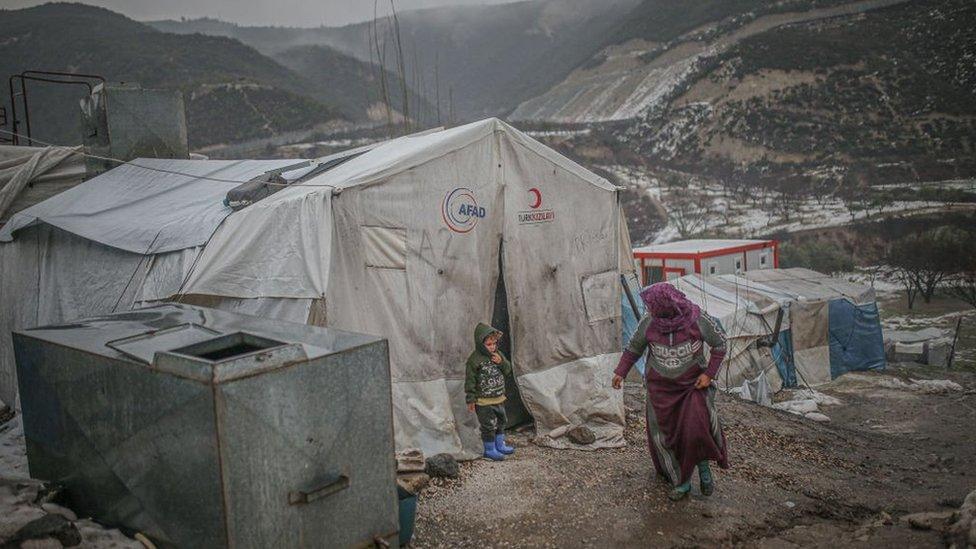 A woman and a child at a camp for displaced people in Idlib province, north-western Syria (26 January 2022)