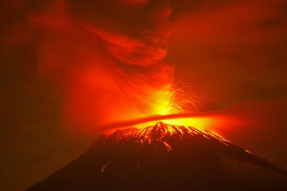 Incandescent materials, ash and smoke are spewed from the Popocatepetl volcano as seen from the San Nicolas de los Ranchos community, state of Puebla, Mexico, on May 23, 2023.