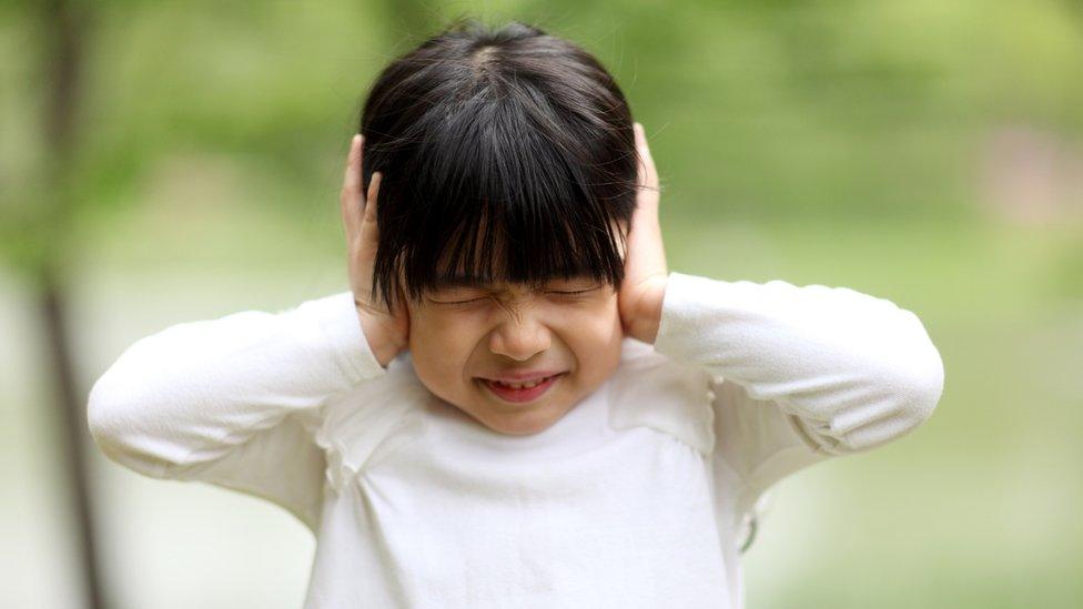 girl-covering-ears.