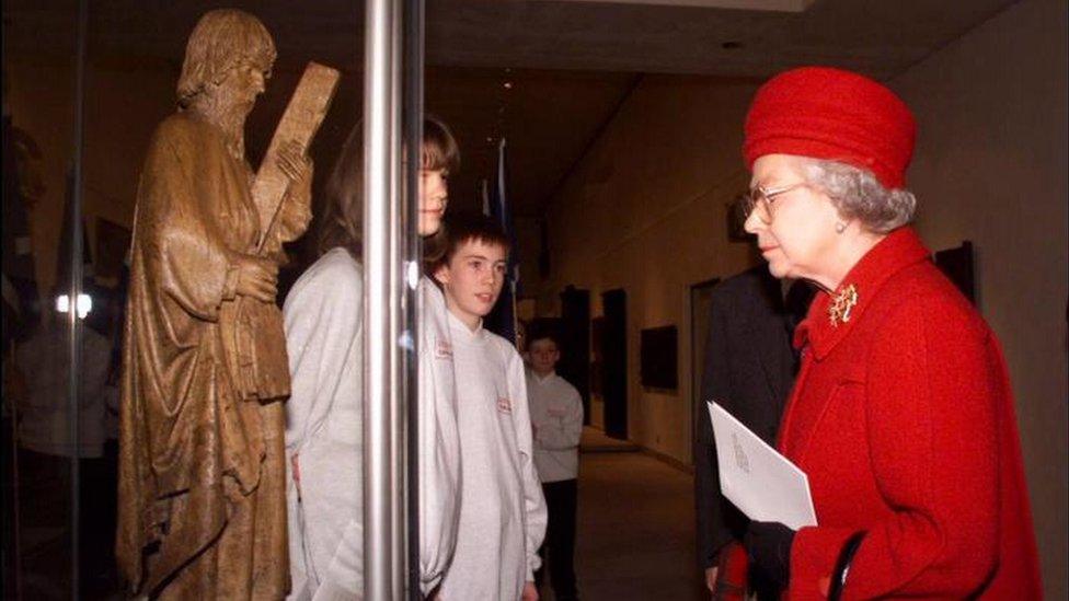 The Queen views an exhibit, during the opening of the New Museum of Scotland, in Edinburgh in 1998