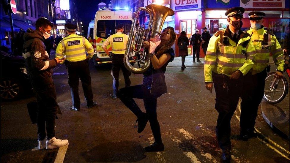 Revellers and police in Soho