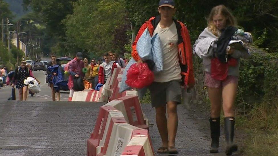 Young people carrying bags as they leave Maes B