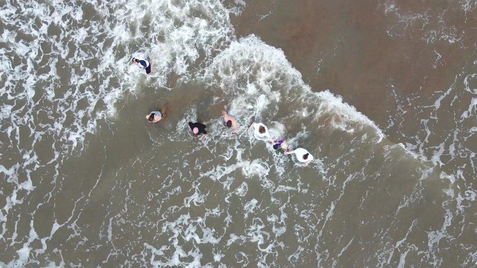 Aerial picture of swimmers entering the water