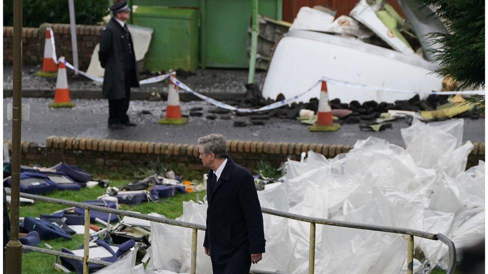 Firth on set with an actor playing a police officer in the background