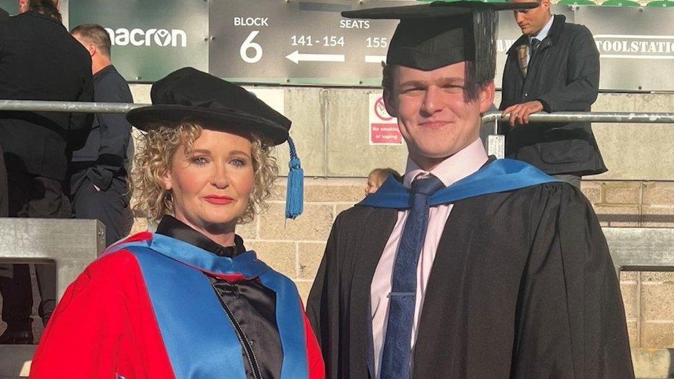 Dr Bill Robertson-Smith (left) and her son Archie Robertson-Smith wearing their graduation gowns and mortar boards