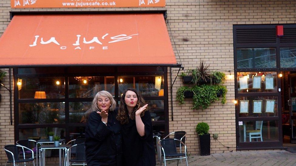 Beatrice Pallister with her mum outside JuJu's Cafe in Birmingham