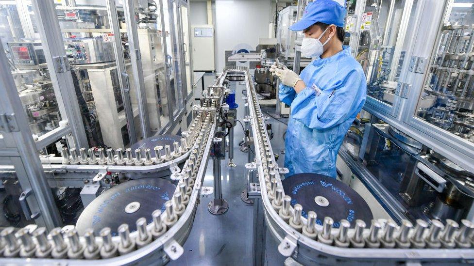 An employee works on the production line of lithium battery at a factory of Tianneng Battery Group in Changxing County, Zhejiang Province of China.