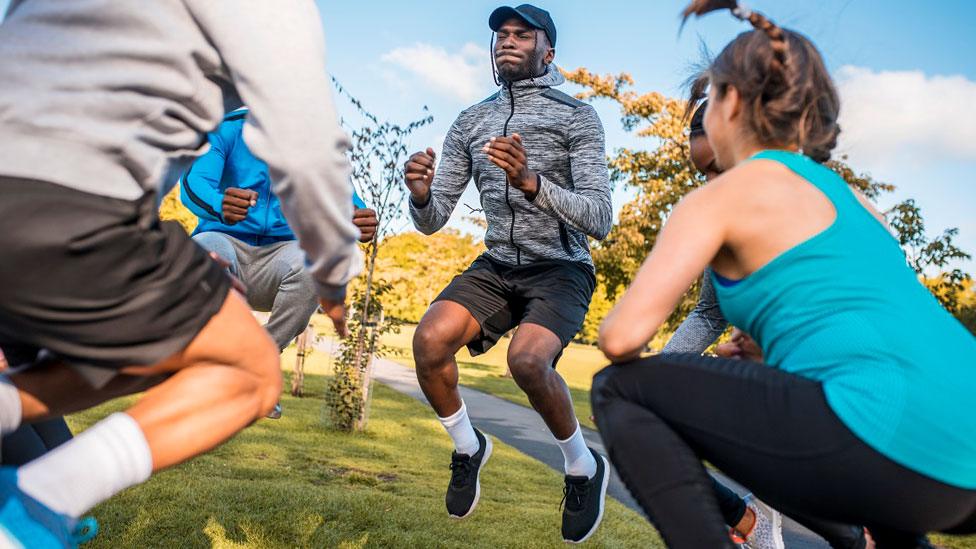 Group of people exercising in park