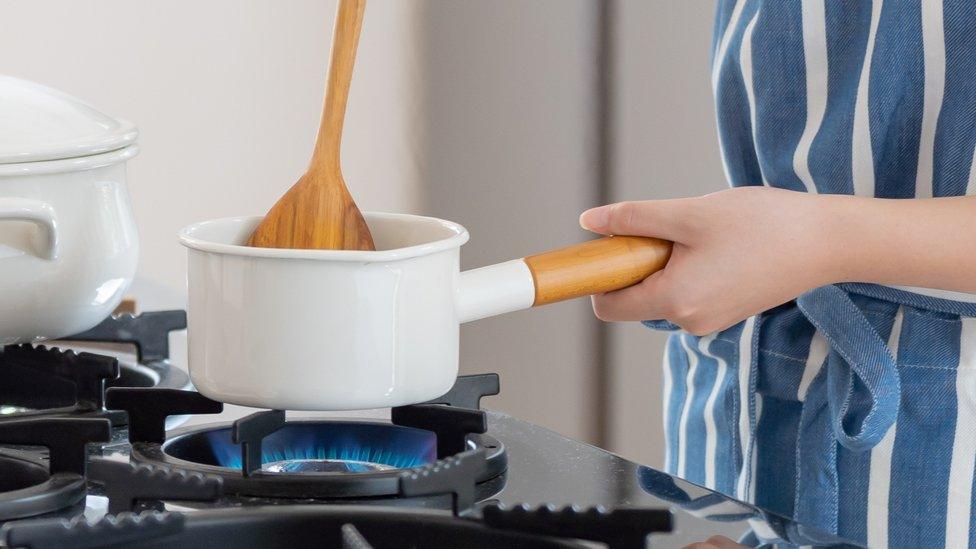 Woman cooking with gas