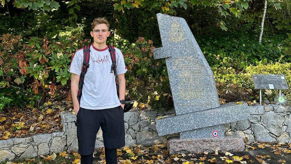 Adam Hart next to war memorial