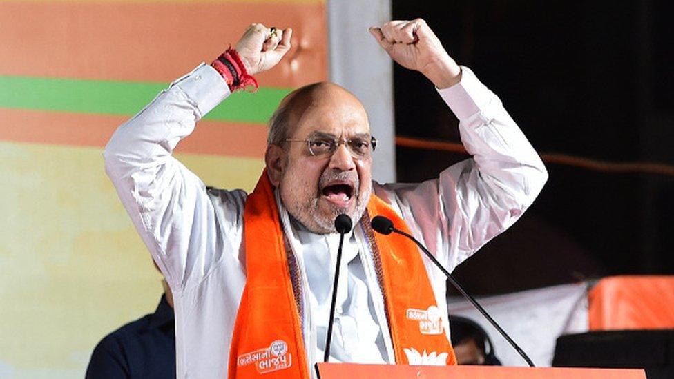 Amit Shah gestures as he speaks during a BJP election rally