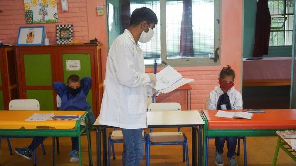 Teacher Sergio Ferraro gives a lesson to his students at Escuela 30, a rural school that has resumed classes after a month off due to the coronavirus disease (COVID-19), in San Jose, Uruguay April 22, 2020