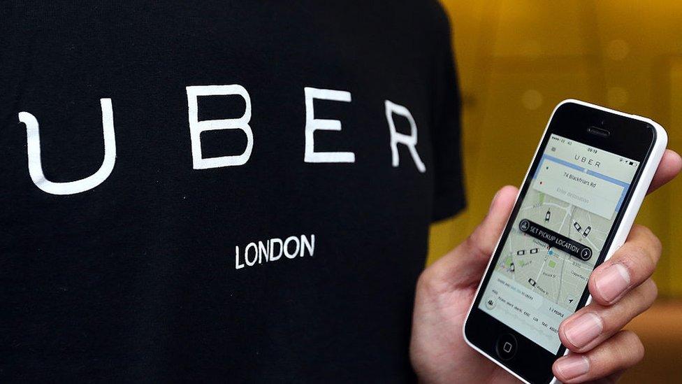 Man using Uber app on a mobile phone