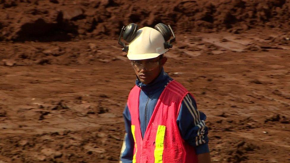 Brazilian worker taking part in clean-up