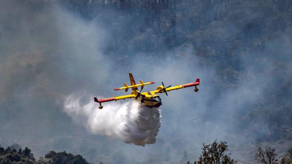 Aircraft with plume of smoke behind it