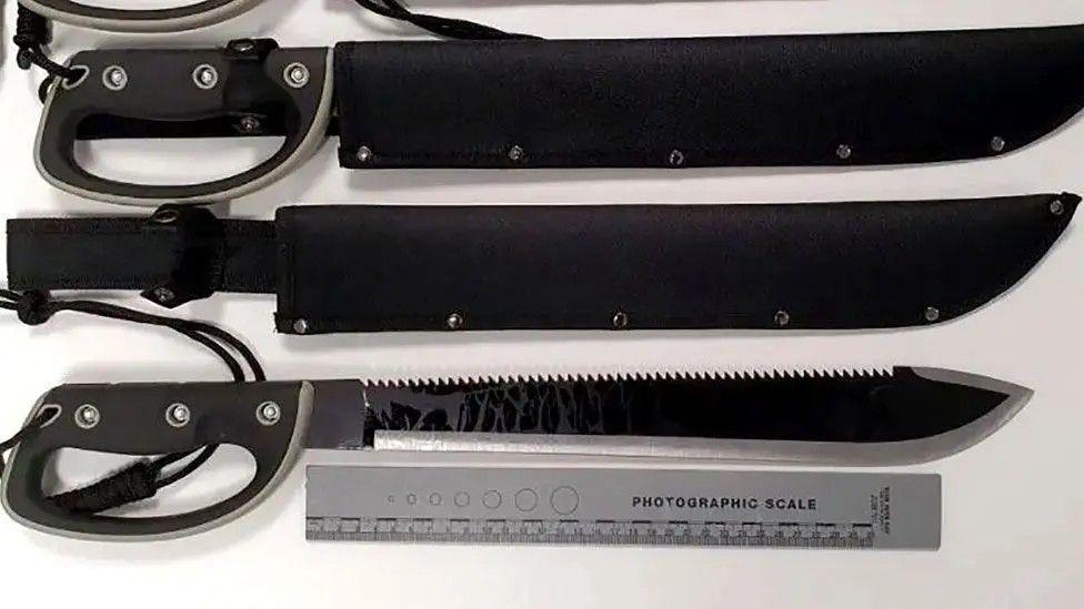 A series of four knives, stacked horizontally, with black handles