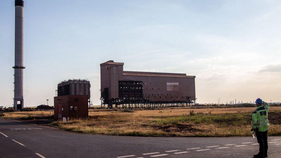 A man looks at the building before its demolition