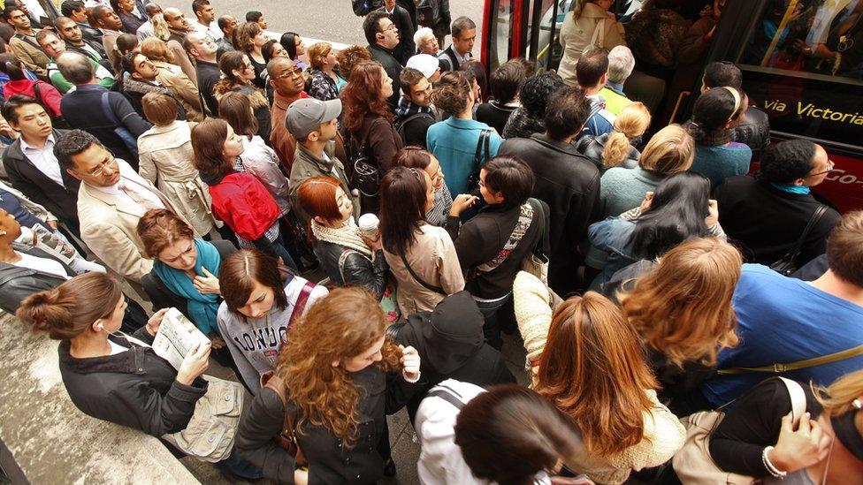 Commuters queue for buses outside Victoria Station