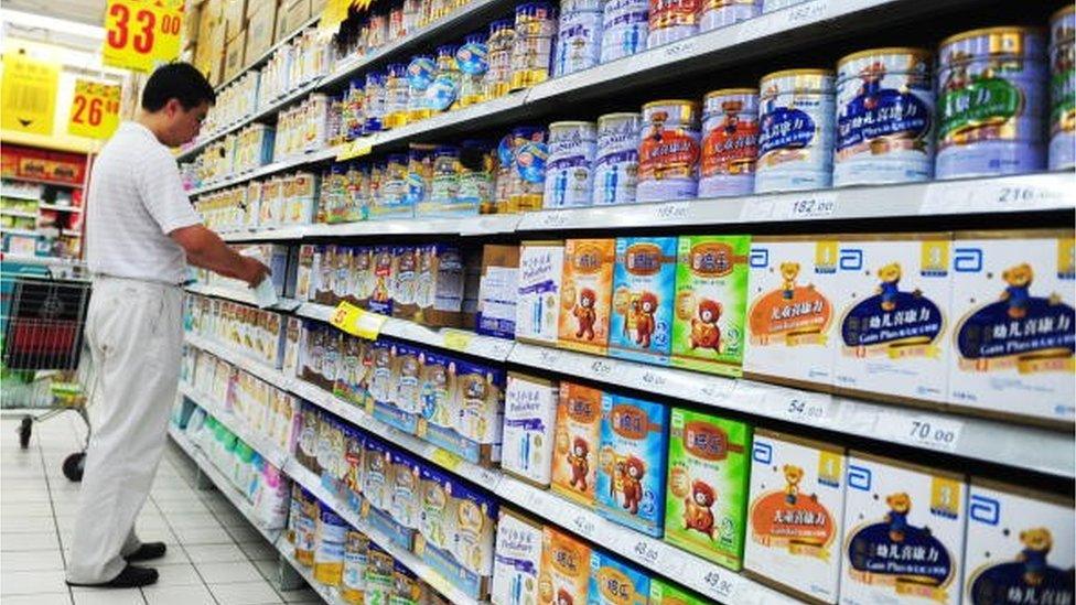 A Chinese man selects milk powder at a supermarket in Beijing on July 9, 2010. Chinese authorities have seized 76 tonnes of milk powder tainted with melamine, the same chemical responsible for the deaths of six babies two years ago, state media said.