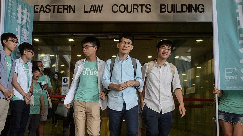 Pro-democracy political activists and members of the Demosisto party (centre back L to R) Nathan Law, Joshua Wong and Alex Chow