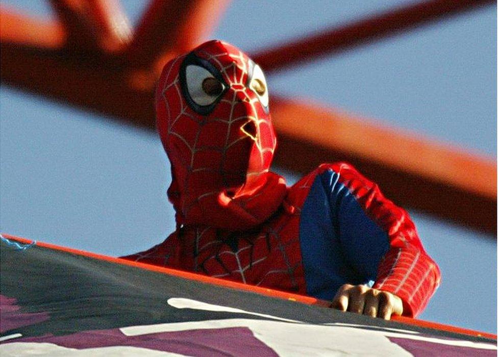 Chick dressed as Spider-Man on a crane near Tower Bridge